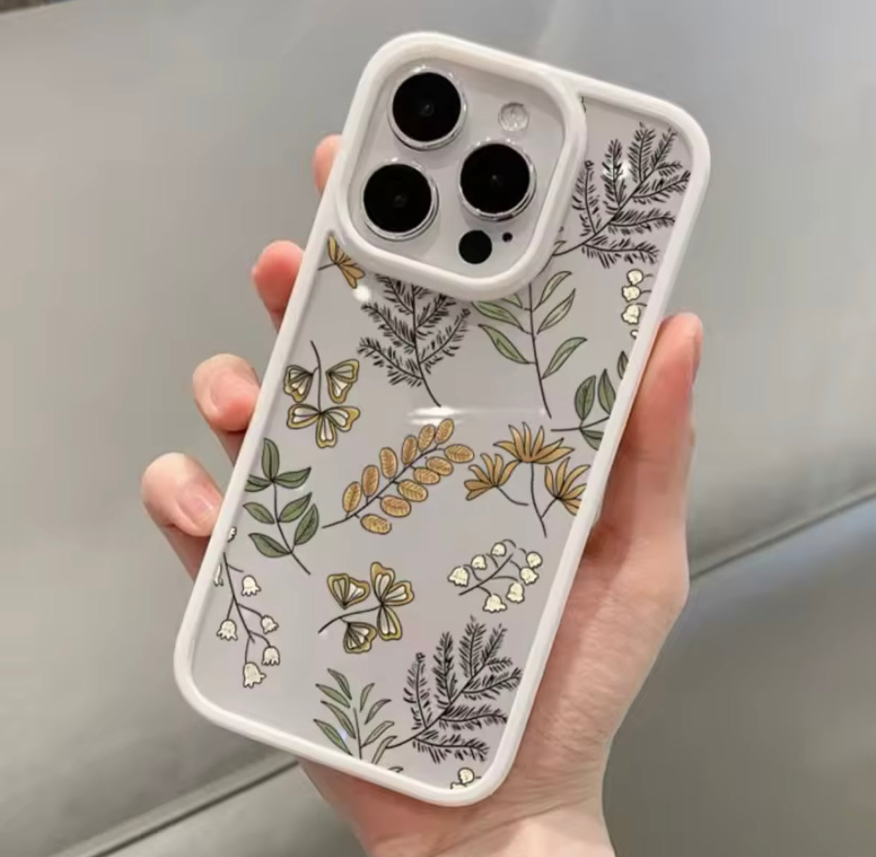 غطاء هاتف آيفون برسومات نباتية بألوان الباستيل (إطار أبيض)